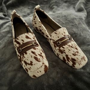 ABLE brand cow-print loafer with leather detailing.
